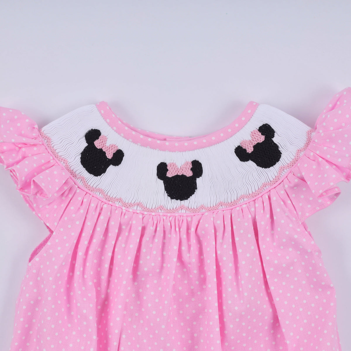 Pink character hand smocked dot ruffle bubble